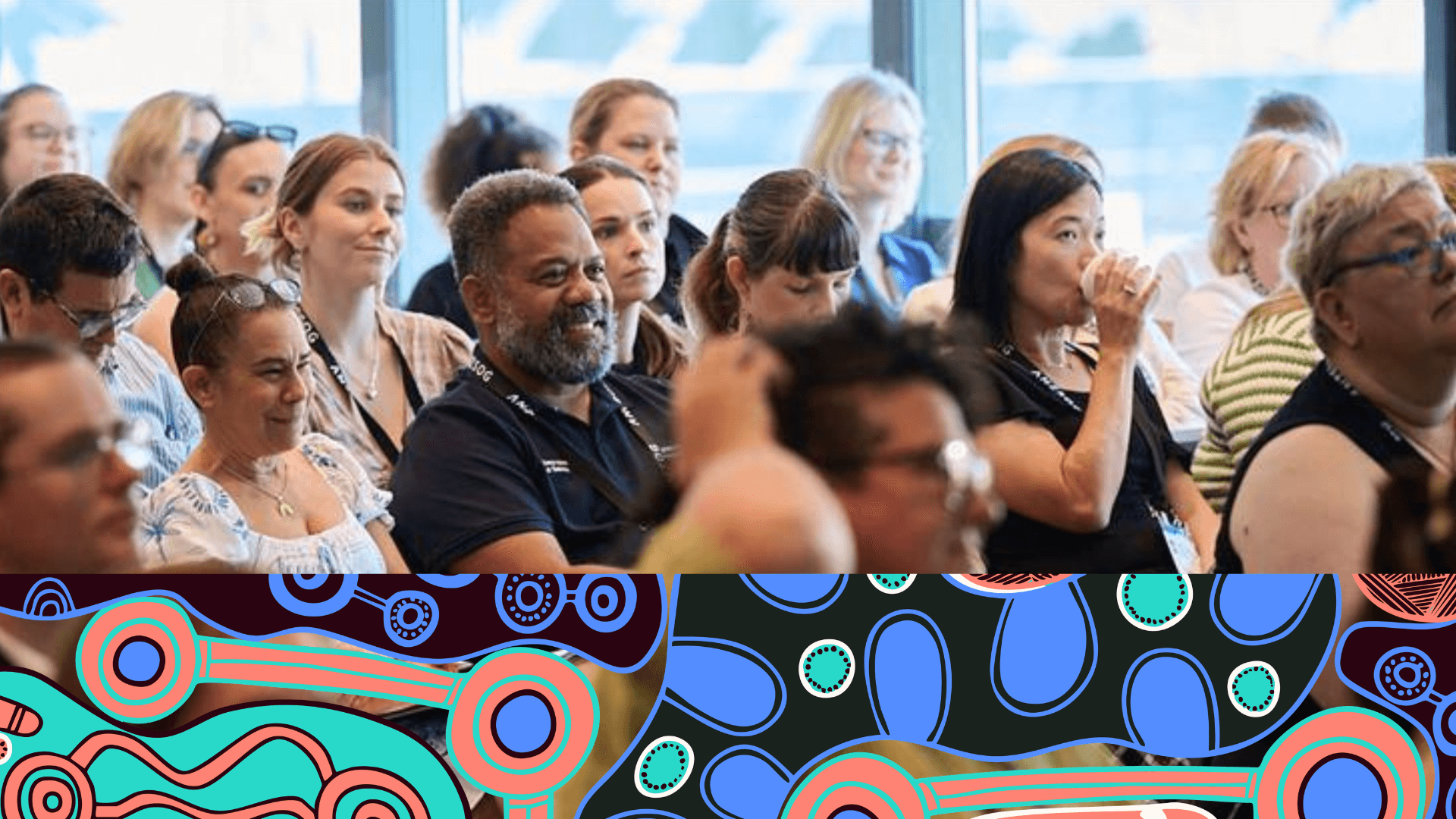 Audience at a conference, attentively listening, with a colorful abstract border overlay at the bottom.