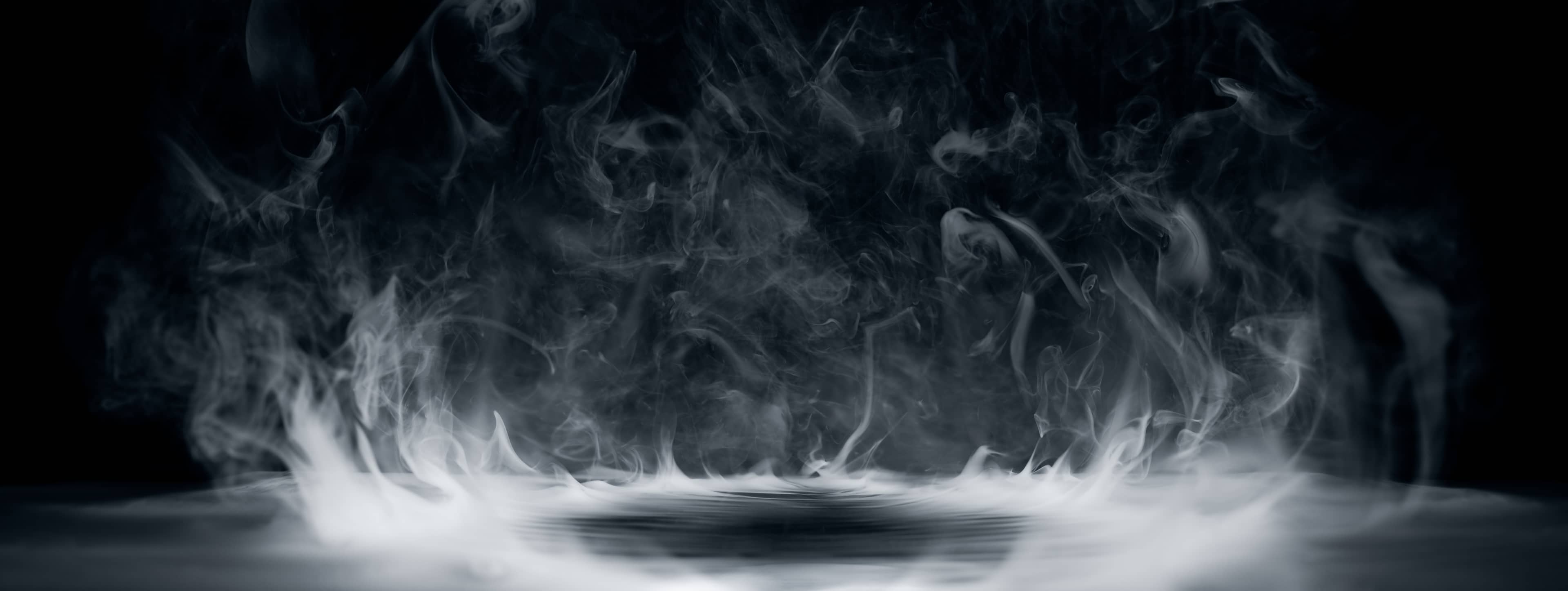 Swirling white smoke rising against a dark background, creating a mysterious and ethereal atmosphere.