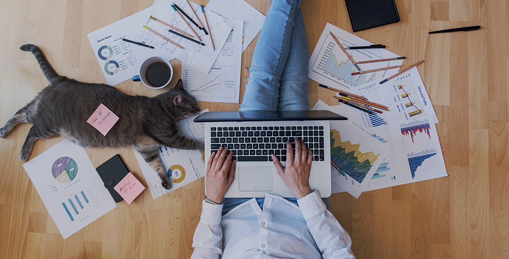 Image of woman working on the floor with cat