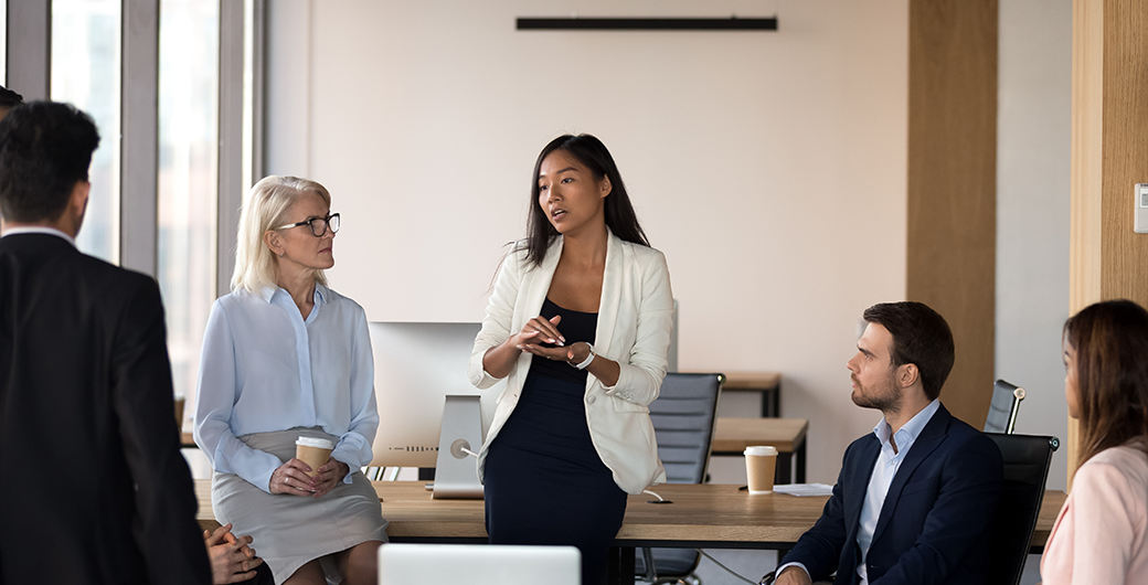 Image of a woman speaking at a group meeting