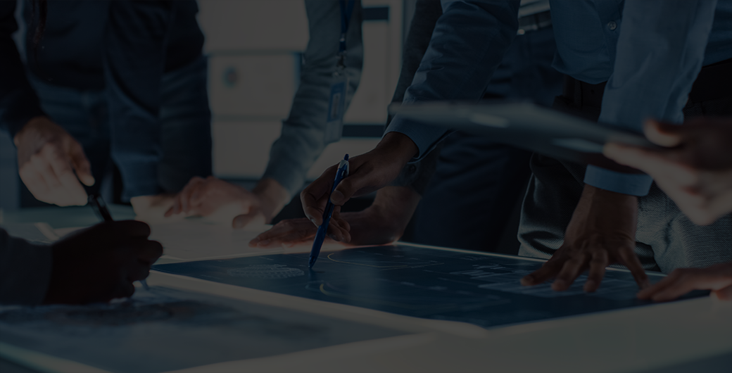 Image of people gathered around illuminated conference table