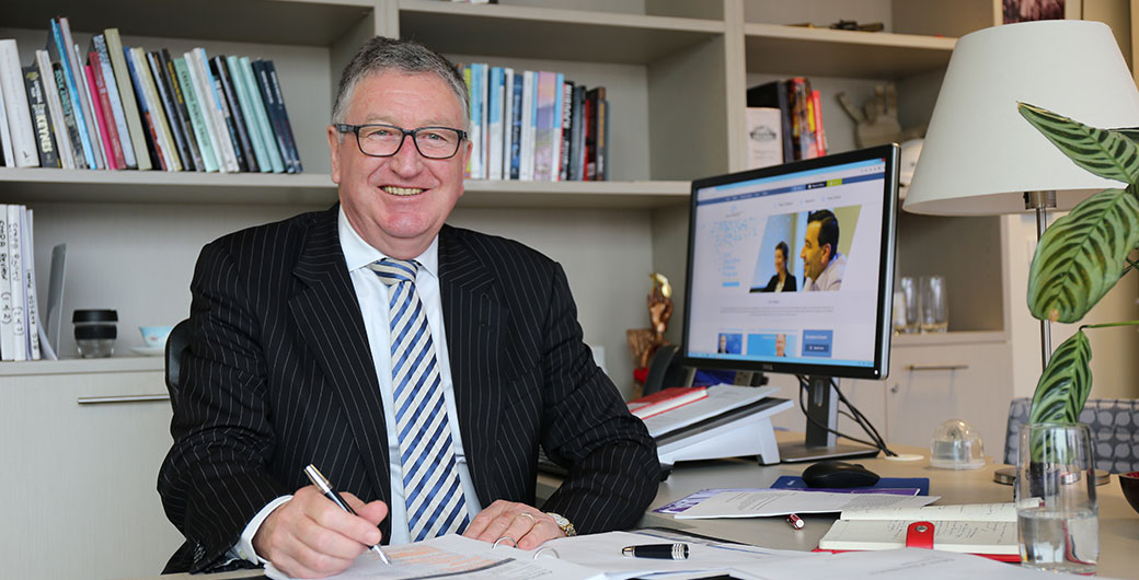 Image of ANZSOG CEO Ken Smith sitting at desk