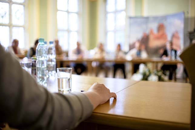 person giving a lecture to a group. Hand in focus