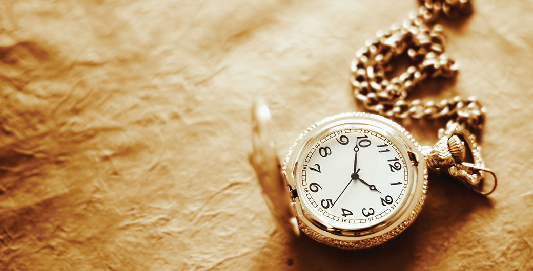 Vintage pocket watch on old paper background