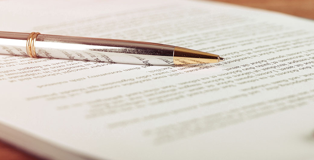 Image of a pen and papers on a table