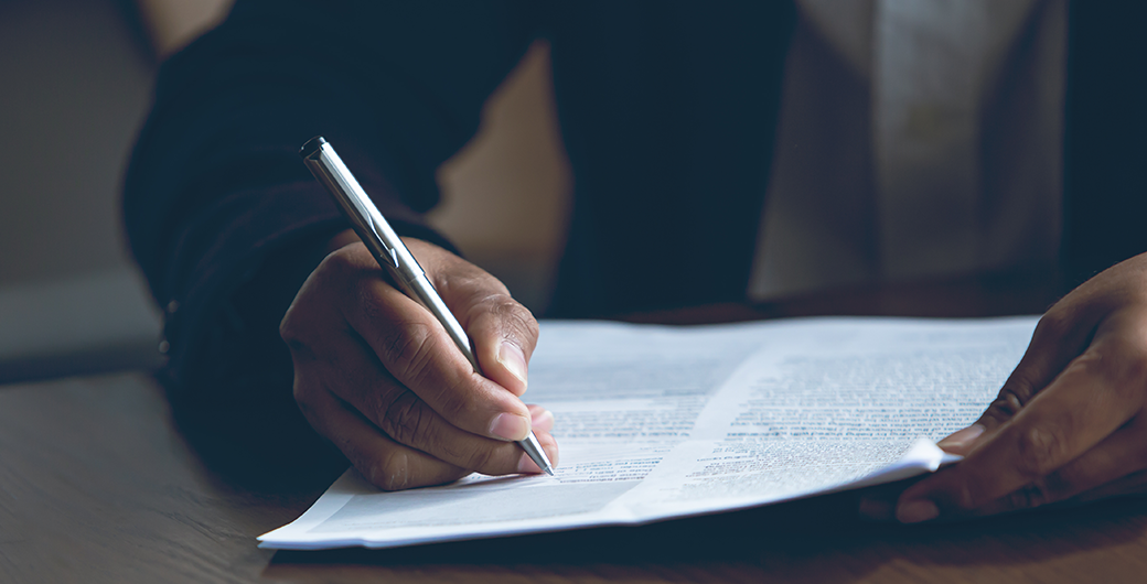 Image of businessman writing on a piece of paper