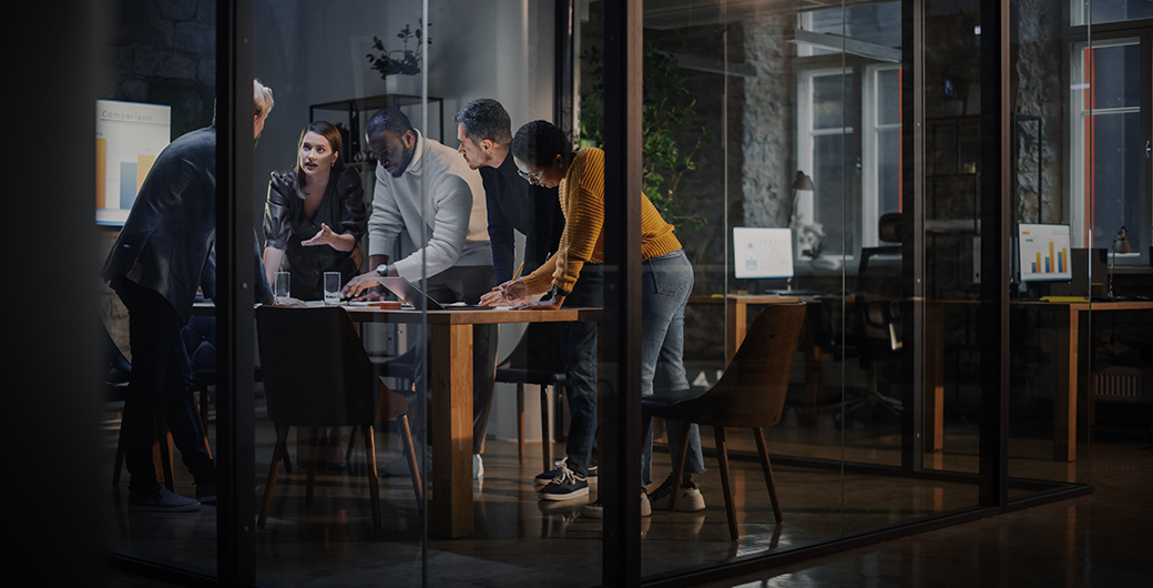 Image of a team having a meeting in a glass office