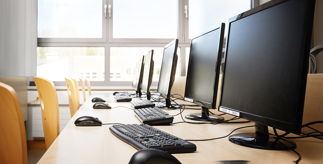 classroom setting with empty desktops