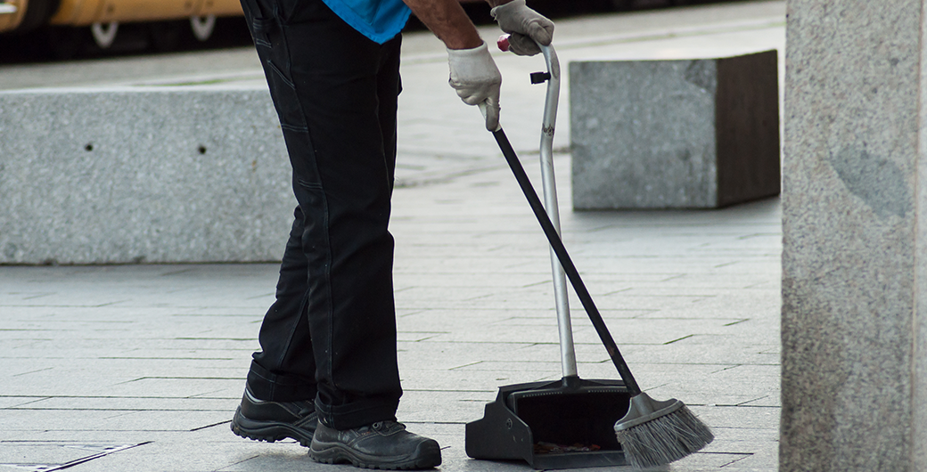 Man sweeping using dustpan and brush