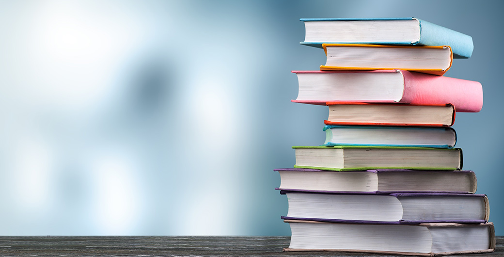 a pile of books on table