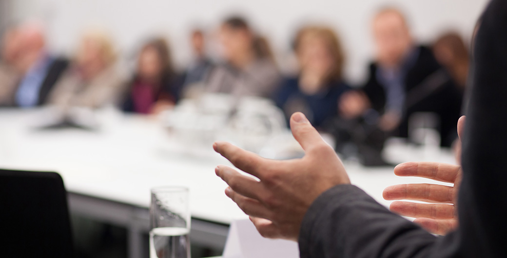 Image of a person delivering a seminar.