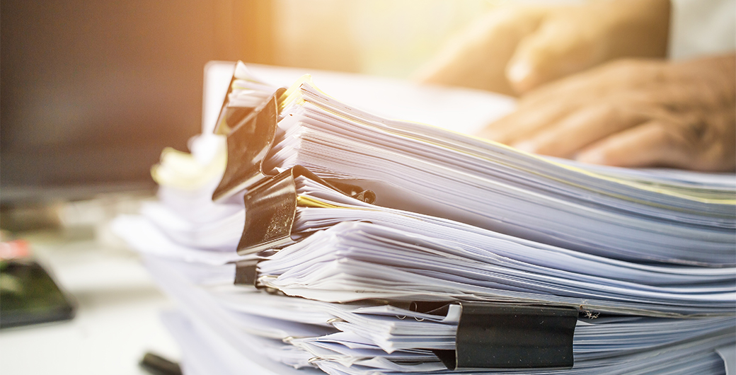 Image of papers stacked on the table.